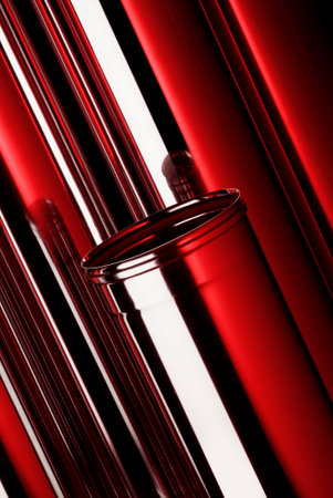 Composition of tubes in polished stainless steel with red reflectionsの写真素材