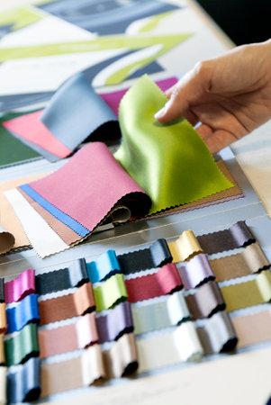 Choice by color of fabrics from the sample bookの写真素材