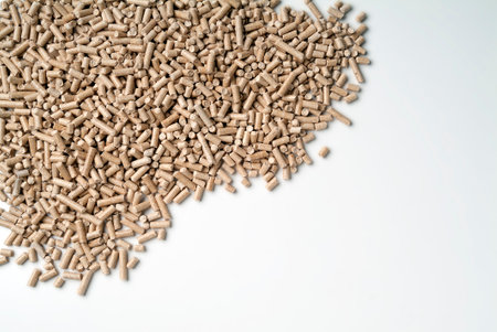 Top view of Scattered heating pellets on white tabletopの写真素材
