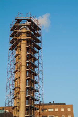 Detail of Chimney surrounded by construction scaffoldingの写真素材