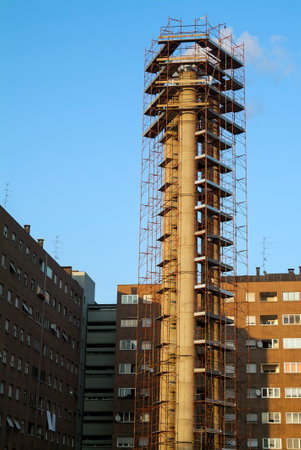 Detail of Chimney surrounded by construction scaffoldingの写真素材