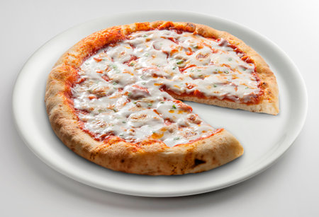 Classic round pizza margherita sliced on white plate isolated on white backgroundの写真素材