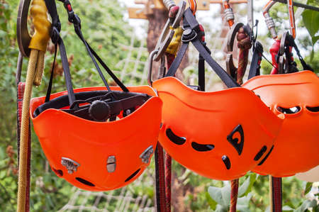 orange helmet hanging on for skalalazaniya carabiner and rope park