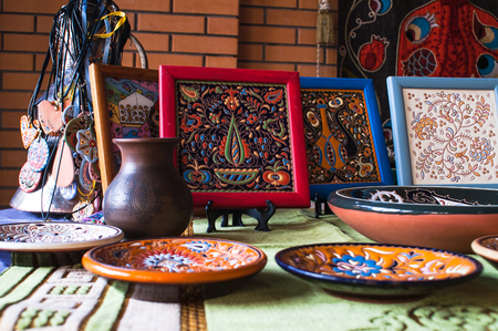 set of dishes by hand on the background of a jugの写真素材