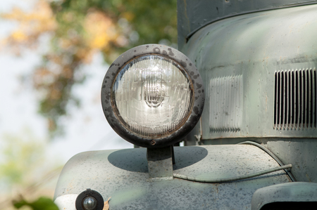 Gray and olive vintage military truck on the roadの写真素材