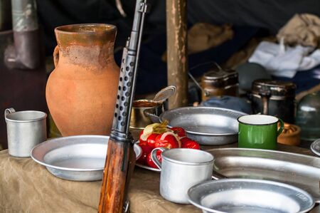 The rifle near a variety of food laid tableの写真素材