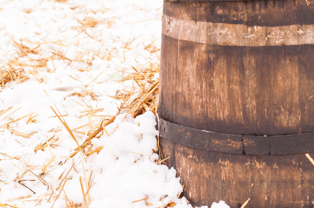 wooden barrel near the straw on the snowの写真素材