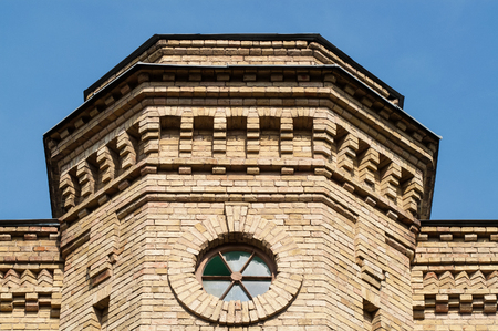 round window in a brick building on a sunny dayの写真素材