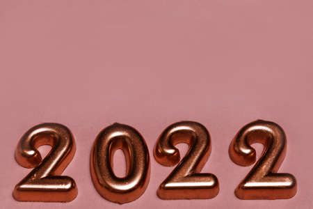 Festive New year and Christmas golden number 2022 on pink backgroundの写真素材