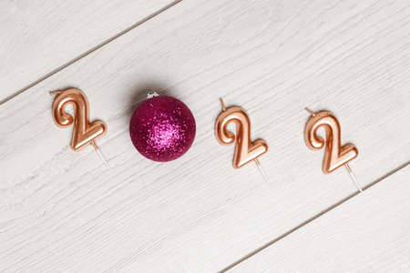 Festive Christmas and new year card with number 2022 on gray wooden background
