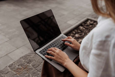 Close up hand of young business woman works for a laptop outdoorの写真素材