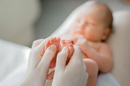 Baby feet in the mother handsの写真素材