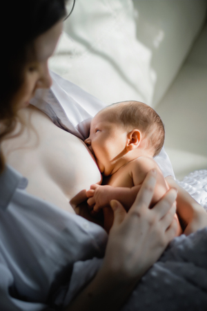 mother feeding her newborn with breastの写真素材