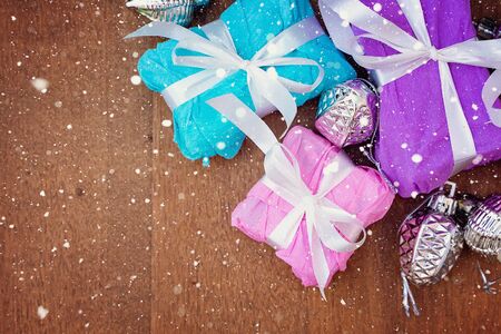 Wooden Christmas background with gift boxes around the perimeter. Wood background. Background,...