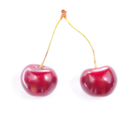Two colorful red cherries isolated on white background.の写真素材