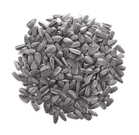 Small pile of sunflower seeds isolated on white background の写真素材