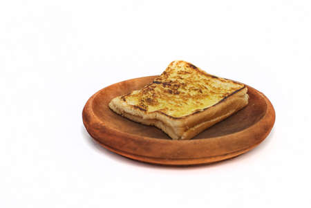 isolated toast on wooden plateの写真素材