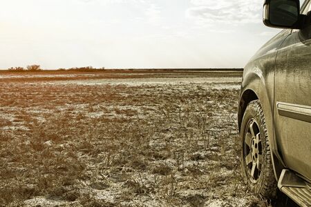 Truck car wheel on offroad deserted steppe adventure trail
