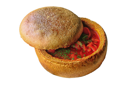 Russian and ukrainian national red soup borsch in a bread plate isolated with clipping pathの写真素材