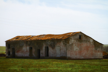 Ruined old cattle stable, damaged by timeの写真素材