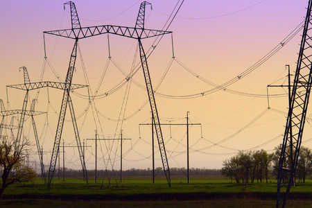 High-voltage power lines at sunset. electricity distribution station.