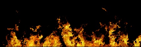 Real fire line flames isolated on black background. Mockup fire wall.