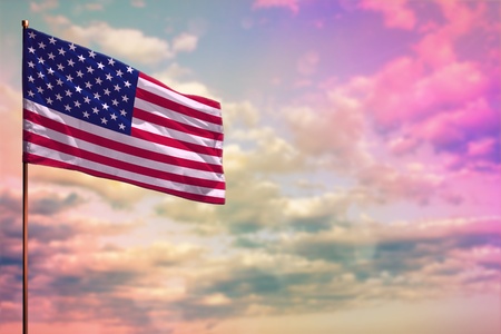 Fluttering USA flag mockup with the place for your text on colorful cloudy sky background.