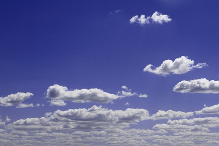 amazing bright blue cumulus clouds in the sky for using as background in design.