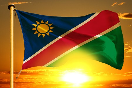Namibia flag weaving on the beautiful orange sunset backgroundの写真素材