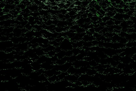 wonderful green shining holiday dark water - abstract background of electric lights reflected in black liquidの写真素材