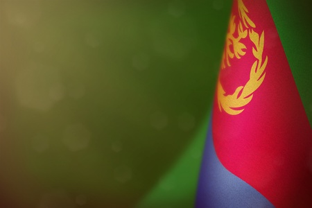 Eritrea hanging flag for honour of veterans day or memorial day on green dark velvet background. Eritrea glory to the heroes of war concept.の写真素材