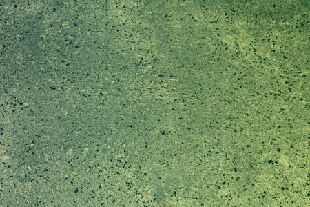 Wonderful orange interspersed scratched plaster on the desk texture - abstract photo backgroundの写真素材