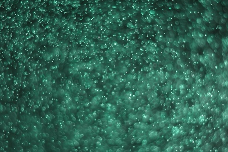 beautiful teal, sea-green many flying festive light bokeh texture - abstract photo backgroundの写真素材