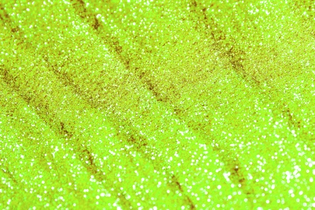 pretty brilliant sand made of brassy glitters with selective focus and small bokeh texture - abstract photo backgroundの写真素材