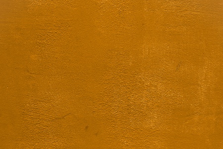 pretty orange dirty concrete with broken paint texture - abstract photo backgroundの写真素材