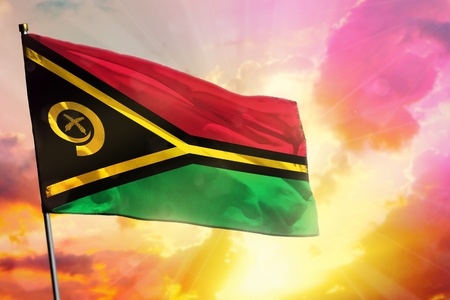 Fluttering Vanuatu flag on beautiful colorful sunset or sunrise background. Vanuatu success and...