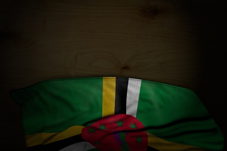 pretty celebration flag 3d illustration
 - dark picture of Dominica flag with big folds on dark wood with free place for your contentの写真素材