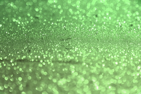 nice green glossy gold sand made of glitters - celebratory concept with bokeh texture - abstract photo backgroundの写真素材