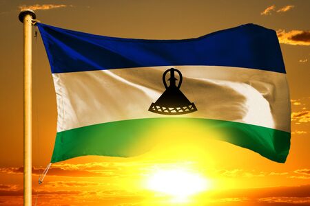 Lesotho flag weaving on the beautiful orange sunset backgroundの写真素材