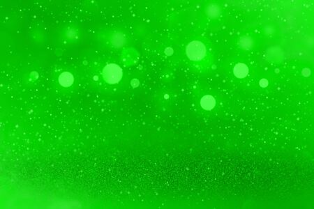 green fantastic brilliant abstract background glitter lights with sparks fly defocused bokeh - festive mockup texture with blank space for your contentの写真素材