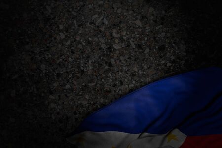 nice national holiday flag 3d illustration
 - dark image of Philippines flag with large folds on dark asphalt with free place for your textの写真素材