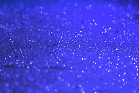 beautiful blue brilliant golden sand made of glitters - club concept with bokeh texture - abstract photo backgroundの写真素材