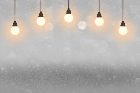 light blue beautiful glossy abstract background glitter lights with light bulbs and falling snow...