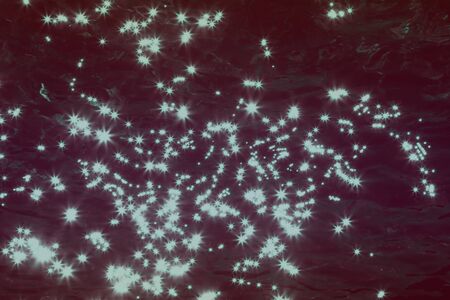 beautiful teal, sea-green shining sparks on dark water surface texture - abstract photo backgroundの写真素材