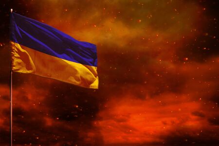Fluttering Ukraine flag mockup with blank space for your data on crimson red sky with smoke pillars background. Ukraine problems concept.の写真素材