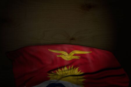 wonderful dark illustration of Kiribati flag with big folds on dark wood with empty space for your content - any holiday flag 3d illustration
の写真素材