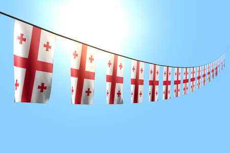 beautiful national holiday flag 3d illustration - many Georgia flags or banners hangs diagonal on rope on blue sky background with selective focusの写真素材