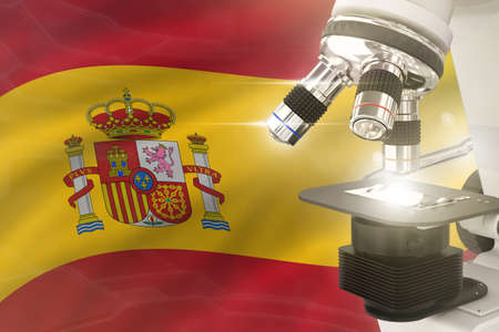Spain science development concept - microscope on flag background. Research in genetics or...