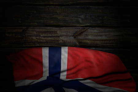 wonderful any feast flag 3d illustration - dark photo of Norway flag with large folds on old wood with empty place for textの写真素材