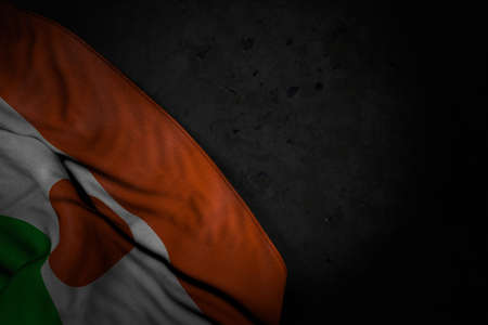 cute independence day flag 3d illustration - dark illustration of Niger flag with large folds on black stone with free place for contentの写真素材